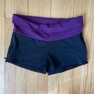 Bebe Sport shorts. Black/Purple. Back zip pocket. 2 side zippers. Size M.